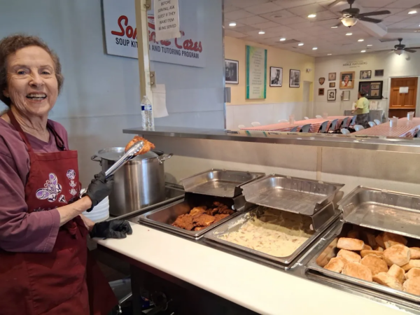 Female volunteer serving food at soup kitchen